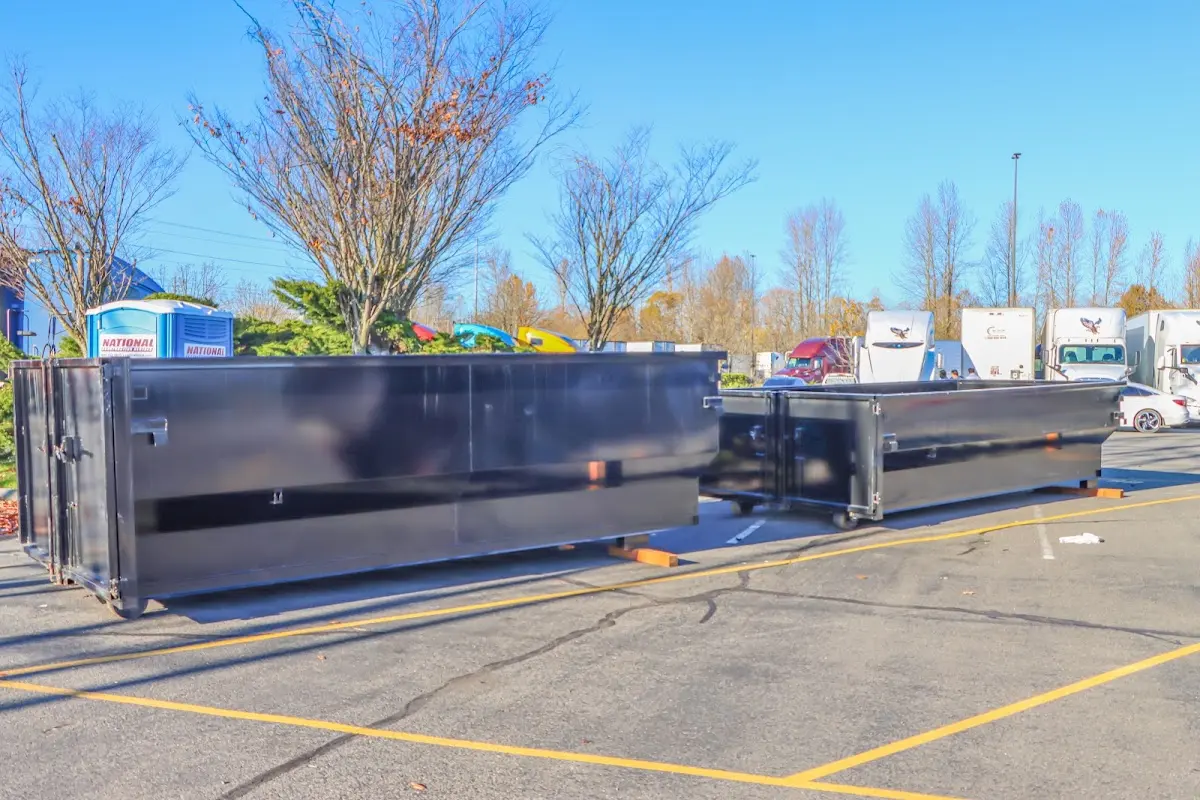 Professional dumpster rental service with roll-off container on residential driveway in Savage